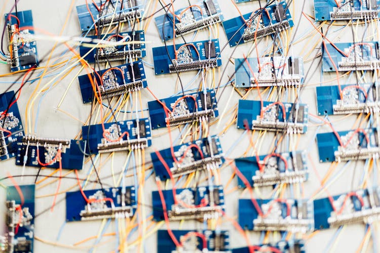 Many chips waiting to be soldered onto a board, representing mass production