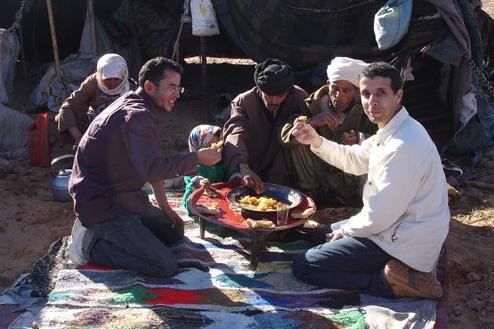 Bedouins eating in front of their tent