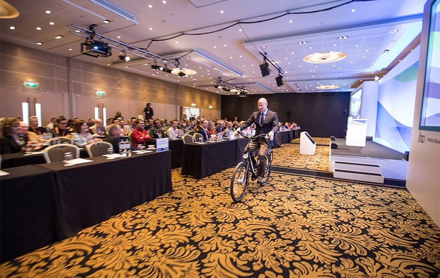 Jeff cycles pass attendees at the Discovery Summit Europe Amsterdam
